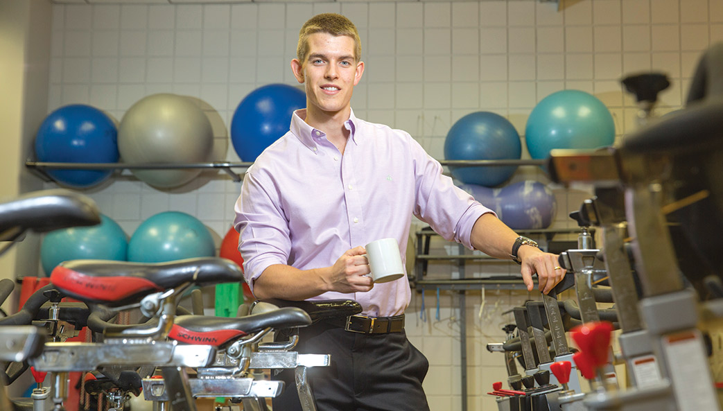 Simon Higgins in exercise room with coffee