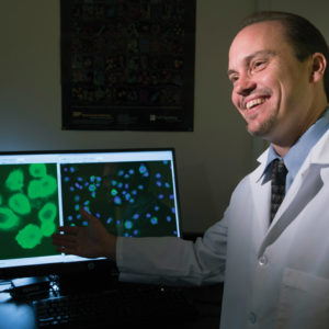 Researcher in front of computer monitor
