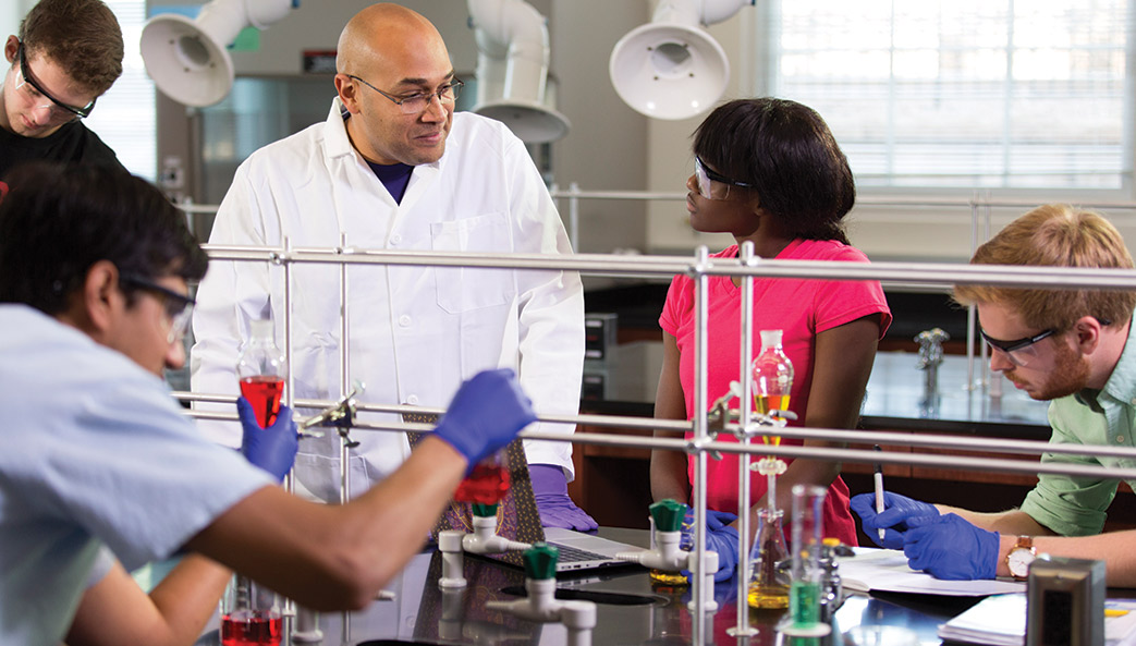 Researcher and students in lab.