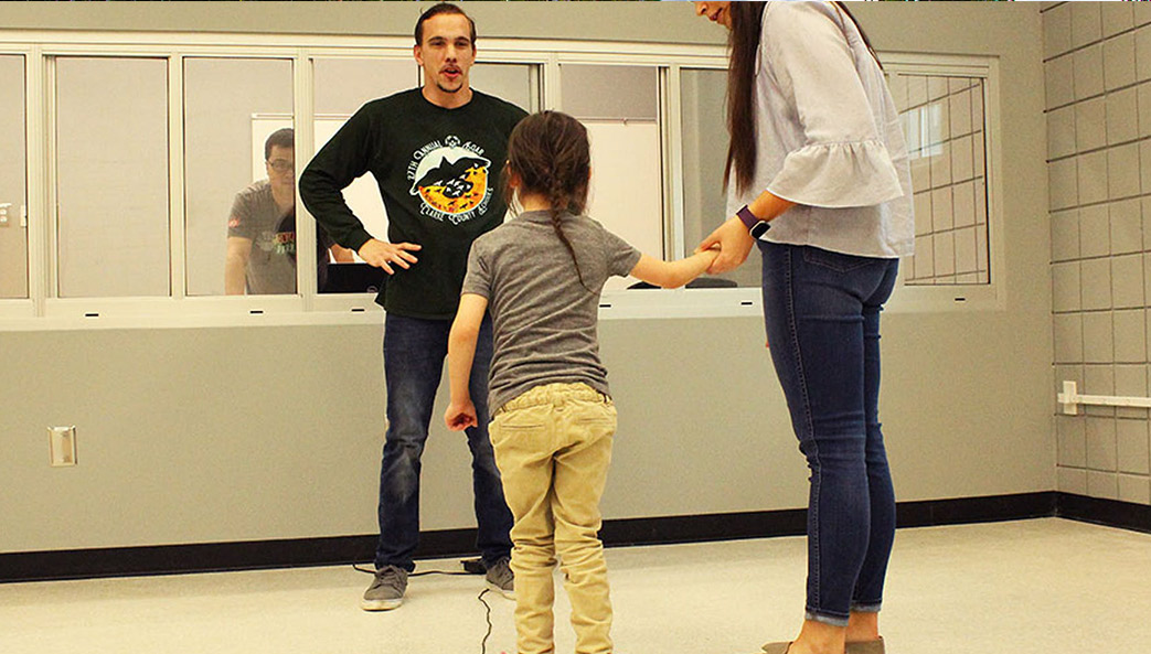 photo of child standing on a vibrating platform at the University of Georgia's Neuromusculoskeletal Health Lab