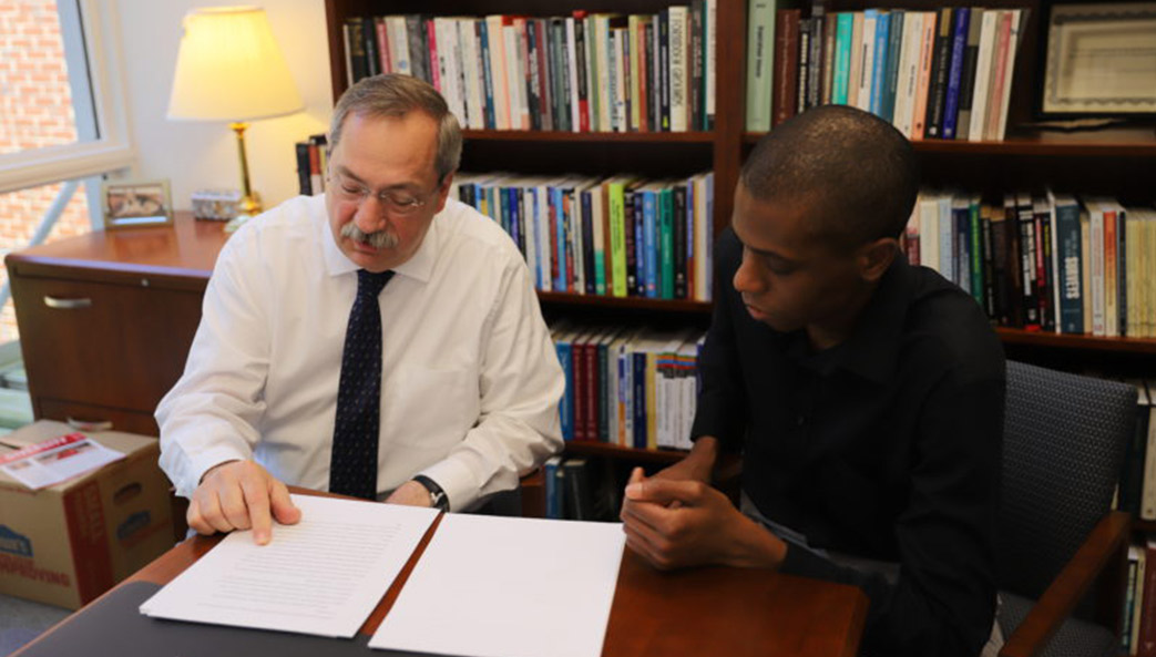 Ed Kellough and his graduate research assistant Lawrence Brown review a paper in Kellough's office.
